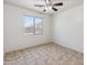 Bedroom featuring a ceiling fan, a window, and tile floors at 15985 W Bartlett Ave, Goodyear, AZ 85338