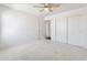 Bedroom with ceiling fan, carpet floors, and closet space at 15985 W Bartlett Ave, Goodyear, AZ 85338