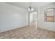 Simple dining room with tiled floors, natural light, and modern chandelier at 15985 W Bartlett Ave, Goodyear, AZ 85338