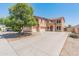 Two-story home with beige stucco, tile roof, and spacious driveway at 15985 W Bartlett Ave, Goodyear, AZ 85338