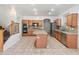 Bright kitchen boasts granite counters, stainless appliances, and central island at 15985 W Bartlett Ave, Goodyear, AZ 85338