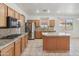 Well-equipped kitchen with stainless steel appliances, granite countertops, and island at 15985 W Bartlett Ave, Goodyear, AZ 85338