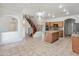 Open kitchen with stainless appliances, granite countertops, and access to the staircase at 15985 W Bartlett Ave, Goodyear, AZ 85338