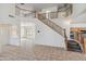 Spacious open-plan living room features high ceilings and a staircase at 15985 W Bartlett Ave, Goodyear, AZ 85338