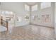 Bright, large living room featuring tile flooring and large windows at 15985 W Bartlett Ave, Goodyear, AZ 85338