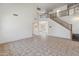 Bright, open living room with two-story staircase and decorative iron railing at 15985 W Bartlett Ave, Goodyear, AZ 85338
