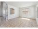 Bright living room featuring tile flooring and several windows at 15985 W Bartlett Ave, Goodyear, AZ 85338