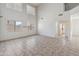 Bright, large living room featuring tile flooring and large windows at 15985 W Bartlett Ave, Goodyear, AZ 85338