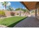An open backyard features green turf, desert plants, and a grill setup at 16436 S 1St Ave, Phoenix, AZ 85045