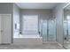 Bathroom with a soaking tub, walk-in shower, and towel rack at 16436 S 1St Ave, Phoenix, AZ 85045