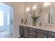 Bright bathroom with dual sinks, decorative mirrors, and a separate shower/tub area at 16436 S 1St Ave, Phoenix, AZ 85045