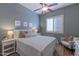 Comfortable bedroom with ceiling fan, shuttered window, and neutral color palette at 16436 S 1St Ave, Phoenix, AZ 85045