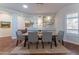 Dining area with hardwood floors, stylish chairs, a modern light fixture, and built-in shelving at 16436 S 1St Ave, Phoenix, AZ 85045