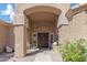 Elegant front entryway featuring double doors, textured pillars, desert landscaping, and a welcoming walkway at 16436 S 1St Ave, Phoenix, AZ 85045