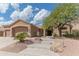 Inviting exterior with a two-car garage, desert landscaping, stone accents, and a charming entryway with steps at 16436 S 1St Ave, Phoenix, AZ 85045