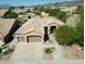 Aerial view of a home with a three-car garage, desert landscaping, and a tile roof at 16436 S 1St Ave, Phoenix, AZ 85045