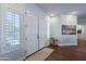 Bright foyer with double doors, white trim, hardwood floors, and a view into the hallway at 16436 S 1St Ave, Phoenix, AZ 85045