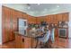 Bright kitchen features granite counters, stainless steel appliances, wine cooler, and island with seating at 16436 S 1St Ave, Phoenix, AZ 85045