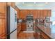 Kitchen with stainless appliances, granite counters, tile backsplash, and hardwood floors at 16436 S 1St Ave, Phoenix, AZ 85045