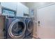 Convenient laundry room with front-load washer and dryer, plus storage cabinets at 16436 S 1St Ave, Phoenix, AZ 85045