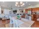 Open concept living room with fireplace, light colored walls, wood floors, and adjoined kitchen at 16436 S 1St Ave, Phoenix, AZ 85045