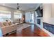 Cozy living room with hardwood floors, a fireplace, and a sliding door that leads to the patio at 16436 S 1St Ave, Phoenix, AZ 85045
