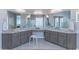 Bathroom featuring dual sinks, granite counters, vanity, and walk-in shower at 16436 S 1St Ave, Phoenix, AZ 85045