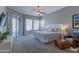 Spacious main bedroom featuring carpet, ceiling fan, and sliding door to the backyard at 16436 S 1St Ave, Phoenix, AZ 85045