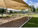 Shaded playground area with swings and wood chip ground cover in the community park at 16436 S 1St Ave, Phoenix, AZ 85045