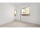 Well-lit bedroom features a double-paned window and neutral colored carpet at 16455 W Avenida Del Sol --, Surprise, AZ 85387
