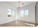 Bright, sunny dining room with tiled floors, large windows, and modern light fixture at 16455 W Avenida Del Sol --, Surprise, AZ 85387