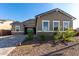 Charming home with a two-car garage, stone veneer accents, and a welcoming entrance at 16455 W Avenida Del Sol --, Surprise, AZ 85387