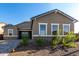 Charming single-Gathering home with gray stucco, stone accents, and neat landscaping, under a clear blue sky at 16455 W Avenida Del Sol --, Surprise, AZ 85387
