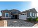 Beautiful home with a two-car garage, stone veneer accents, and a charming paver driveway at 16455 W Avenida Del Sol --, Surprise, AZ 85387