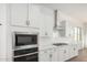 Close-up of a kitchen showcasing stainless steel appliances, white subway tile backsplash, and sleek white countertops at 16455 W Avenida Del Sol --, Surprise, AZ 85387