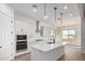 Modern kitchen with white cabinetry, stainless steel appliances, an island with a sink, and ample natural light at 16455 W Avenida Del Sol --, Surprise, AZ 85387