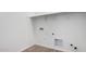A simple laundry room with essential plumbing, simple shelf, and neutral walls at 16455 W Avenida Del Sol --, Surprise, AZ 85387