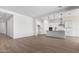 Open-concept layout connecting a modern kitchen to a spacious living area with sleek flooring at 16455 W Avenida Del Sol --, Surprise, AZ 85387