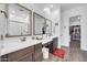 Bright bathroom features dual sinks, modern fixtures, and a walk-in closet at 17003 W Alameda Rd, Surprise, AZ 85387
