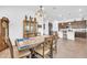 Open concept dining room with a wooden table, chandelier, and direct access to the kitchen at 17003 W Alameda Rd, Surprise, AZ 85387