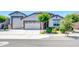 Charming single-story home with a well-manicured front yard and a three-car garage at 17003 W Alameda Rd, Surprise, AZ 85387