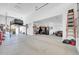 Spacious garage with car lift, high ceilings, work area, and room for multiple vehicles at 17003 W Alameda Rd, Surprise, AZ 85387
