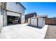 View of a three-car garage and storage shed with a tidy concrete pad at 17003 W Alameda Rd, Surprise, AZ 85387