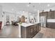 Stylish kitchen with an island, stainless steel appliances, and open to the dining area at 17003 W Alameda Rd, Surprise, AZ 85387