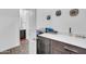 Laundry room with counter space and cabinets, adjacent to a bathroom at 17003 W Alameda Rd, Surprise, AZ 85387