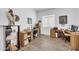 Office space features two desks, wood-look tile flooring, and neutral walls at 17003 W Alameda Rd, Surprise, AZ 85387
