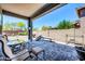 Covered patio with outdoor seating and a view of the gravel backyard with desert landscape at 17003 W Alameda Rd, Surprise, AZ 85387