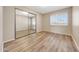 Cozy bedroom featuring laminate floors, a sliding mirror closet, and a window with natural light at 1712 E Manhatton Dr, Tempe, AZ 85282