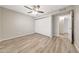 Bedroom featuring laminate floors, neutral walls, a ceiling fan, and a sliding door closet at 1712 E Manhatton Dr, Tempe, AZ 85282