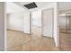 Bright bedroom showcasing tile flooring, neutral paint, and multiple doorways adding natural light at 1712 E Manhatton Dr, Tempe, AZ 85282